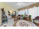 Bright sunroom with rattan furniture, tile floor, and views to living spaces at 4050 Oakhurst Dr # 3175, Sarasota, FL 34233