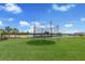 The large backyard features a trampoline and a lake view at 411 158Th E St, Bradenton, FL 34212