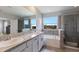 A spacious bathroom with a double vanity, a shower and a soaking tub under a window at 411 158Th E St, Bradenton, FL 34212