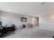 Open bonus room boasts an entertainment area, neutral paint, carpet, and a sunny window at 411 158Th E St, Bradenton, FL 34212