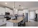Bright kitchen featuring white cabinets, stainless appliances, a granite island, and stylish bar stools at 411 158Th E St, Bradenton, FL 34212