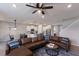 Open concept living room features a leather sectional, ceiling fan and views of the kitchen and dining area at 411 158Th E St, Bradenton, FL 34212