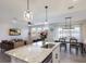 Bright, open-concept living space featuring a granite kitchen island, dining area, and comfortable living room at 411 158Th E St, Bradenton, FL 34212
