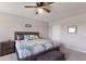 Bedroom with a ceiling fan, plush bed, bedside tables, and soothing neutral tones at 411 158Th E St, Bradenton, FL 34212