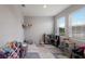 Bright playroom features two windows, neutral paint, toy storage and a rainbow themed floor mat at 411 158Th E St, Bradenton, FL 34212