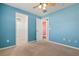 Bright bedroom with a ceiling fan, closet and view into the hallway at 4117 Malden Dr, Sarasota, FL 34241