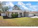 Charming home with a well-manicured lawn, complemented by mature landscaping and an attached two-car garage at 4117 Malden Dr, Sarasota, FL 34241