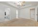 Spacious main bedroom featuring a ceiling fan, tray ceiling, and access to a closet and attached bathroom at 4117 Malden Dr, Sarasota, FL 34241