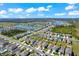 A picturesque aerial view of a residential community with a lake in the background on a clear, sunny day at 4205 Willow Hammock Dr, Palmetto, FL 34221