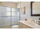 Modern bathroom with tiled shower, vanity and mirror at 4335 Maceachen Blvd, Sarasota, FL 34233
