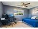 A bedroom with great natural light with a desk and blue comforter at 4335 Maceachen Blvd, Sarasota, FL 34233