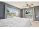 Charming bedroom featuring tile floors and ample natural light through large windows at 4335 Maceachen Blvd, Sarasota, FL 34233