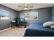 Bedroom with a ceiling fan, a desk area, and tiled floors, lit by natural light from two windows at 4335 Maceachen Blvd, Sarasota, FL 34233