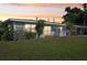 A charming single-story house with a green lawn and a welcoming front porch at 4335 Maceachen Blvd, Sarasota, FL 34233
