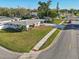 This well-manicured home features lush green lawns and a neatly paved sidewalk enhancing its curb appeal at 4335 Maceachen Blvd, Sarasota, FL 34233