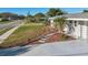 A beautifully landscaped home with a stone walkway leads to a welcoming entrance, showcasing lush greenery at 4335 Maceachen Blvd, Sarasota, FL 34233