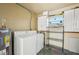 Utility room featuring washer, dryer, and storage shelving at 4335 Maceachen Blvd, Sarasota, FL 34233