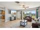 Bright living room with a ceiling fan, tile floors, and a large window for natural light at 4335 Maceachen Blvd, Sarasota, FL 34233