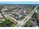 Wide aerial view of a residential neighborhood, showcasing the layout and nearby highway at 441 Rubens E Dr, Nokomis, FL 34275