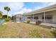 Large grassy backyard with covered patio and screened in pool, great for outdoor entertaining at 441 Rubens E Dr, Nokomis, FL 34275