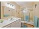 Bathroom featuring vanity, glass door shower/tub, and nautical wall decorations at 441 Rubens E Dr, Nokomis, FL 34275