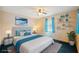 Inviting bedroom featuring a queen bed, soft blue accents, and a cozy atmosphere at 441 Rubens E Dr, Nokomis, FL 34275