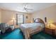 Bedroom featuring a ceiling fan, side table lamps, and neutral wall paint with a carpeted floor at 441 Rubens E Dr, Nokomis, FL 34275