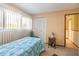 Bright bedroom with natural light, large window, closet, and door leading to the hall at 441 Rubens E Dr, Nokomis, FL 34275