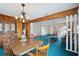 Spacious dining room features a wood table, chandelier, and wood paneled walls at 441 Rubens E Dr, Nokomis, FL 34275