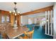 Dining room with blue carpeting, light fixture, and wood trim at 441 Rubens E Dr, Nokomis, FL 34275