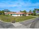 Street view of single-story home with a red tile roof, palm trees, and green lawn at 441 Rubens E Dr, Nokomis, FL 34275
