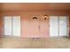 Covered front porch with a pink painted front door and two sliding glass doors at 441 Rubens E Dr, Nokomis, FL 34275