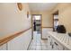 Hallway features white wainscoting, tile floors, skylight view into the kitchen, and interior view at 441 Rubens E Dr, Nokomis, FL 34275