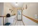 Hallway features white wainscoting, tile floors, wooden butcher block decorations and rear door at 441 Rubens E Dr, Nokomis, FL 34275