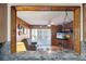 Living room featuring wood paneling, a ceiling fan, sliding glass doors, and views of the lanai at 441 Rubens E Dr, Nokomis, FL 34275