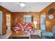 Living room with unique wood paneled walls and tiled floor at 441 Rubens E Dr, Nokomis, FL 34275