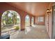 Arched doorway on a covered and enclosed front porch with light stone flooring at 441 Rubens E Dr, Nokomis, FL 34275