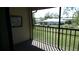 Enclosed balcony with a view of the community's manicured lawn and surrounding homes in a peaceful setting at 4412 Spicewood Dr # D, Bradenton, FL 34208