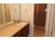 Bathroom featuring vanity with wood cabinetry, ceramic tile flooring, and glass-enclosed shower stall at 4412 Spicewood Dr # D, Bradenton, FL 34208