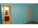 This bright bedroom has wood floors and a view into the attached bathroom at 4412 Spicewood Dr # D, Bradenton, FL 34208