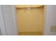 Walk-in closet showcasing an open storage area, wood closet rod, and ceramic tile flooring at 4412 Spicewood Dr # D, Bradenton, FL 34208