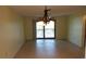 Open dining room features tile floors, a decorative chandelier, and access to the balcony through sliding glass doors at 4412 Spicewood Dr # D, Bradenton, FL 34208