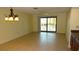 The dining area features neutral walls, tile floors, and a sliding door with access to the balcony at 4412 Spicewood Dr # D, Bradenton, FL 34208