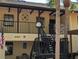 Inviting two-story condo features a painted facade, metal railings, and palm trees at 4412 Spicewood Dr # D, Bradenton, FL 34208