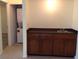 The laundry room features a sink, cabinet storage, and a stacked washer and dryer at 4412 Spicewood Dr # D, Bradenton, FL 34208