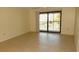 Neutral living space with tile floors, large sliding glass door access to balcony, and natural light at 4412 Spicewood Dr # D, Bradenton, FL 34208