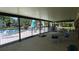 Community pool area with tables and chairs underneath a covered area with view of the water and trees at 4412 Spicewood Dr # D, Bradenton, FL 34208