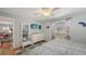 Light-blue bedroom featuring wood floors, a window, and an ensuite bathroom at 4417 Tecumseh Trl # 47, Sarasota, FL 34233