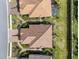 Up close aerial view of homes with tile roofs, well-manicured lawns, and paver driveways in a beautiful community at 4721 Tortona Ct, Bradenton, FL 34211