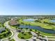 Aerial view of golf course, lakes, and community featuring sidewalks, manicured landscaping, and beautiful homes at 4721 Tortona Ct, Bradenton, FL 34211